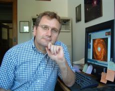 Headshot of Mario Hamuy at his desk