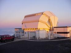 A photo of the Liverpool telescope clamshell enclosure closed with the dawn light falling upon it.